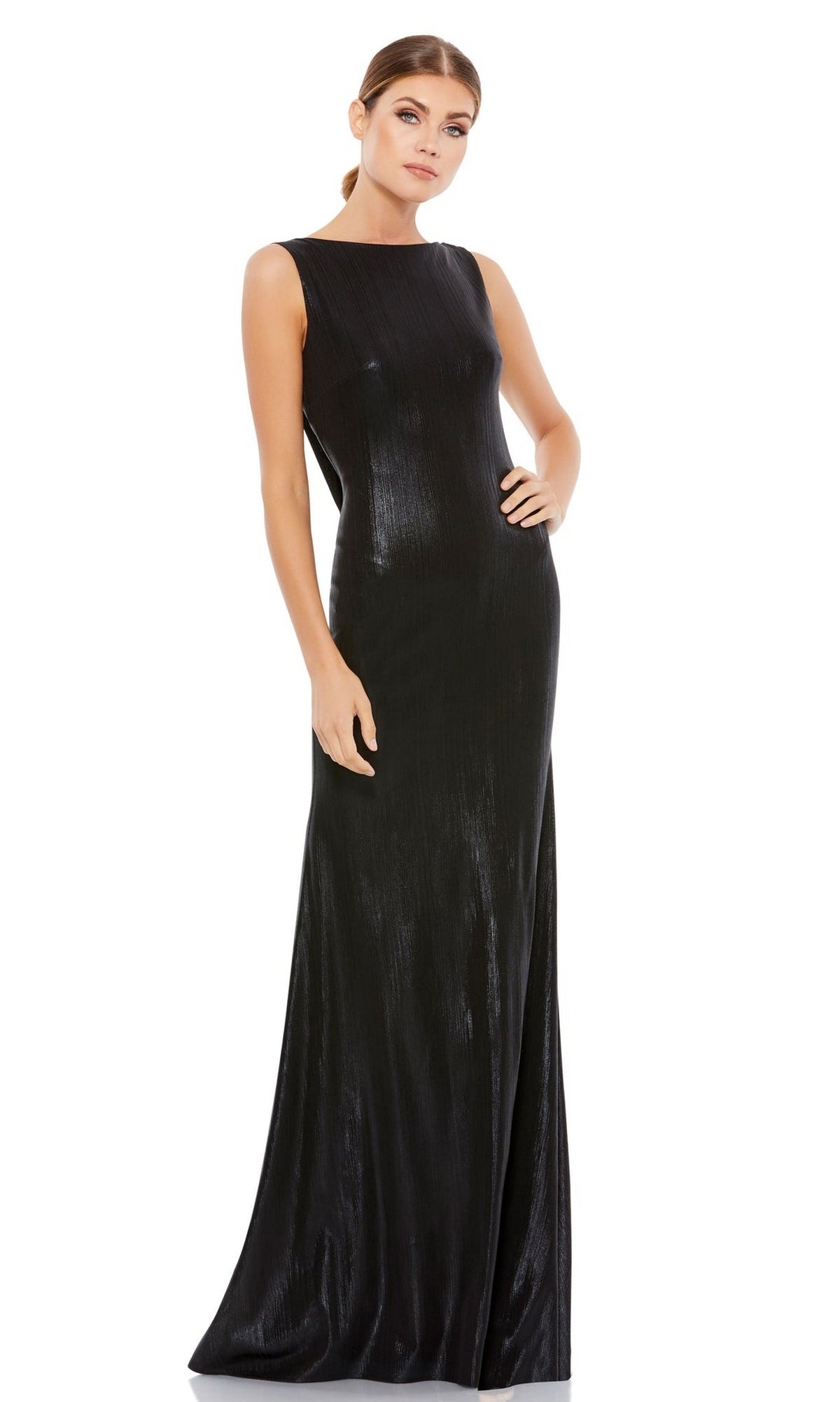 A woman poses against a white background wearing the Mac Duggal 49087 V-Back Long Metallic Prom Dress, a sleeveless, floor-length gown with a cowl back and subtle sheen.